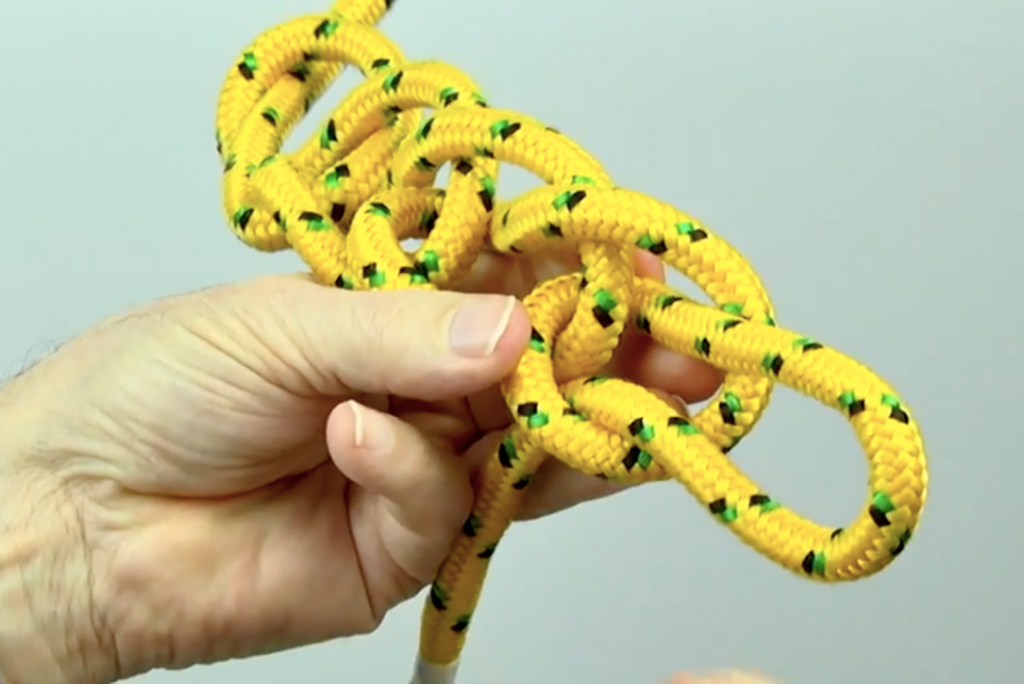 Chain sinnet knot made with yellow cord
